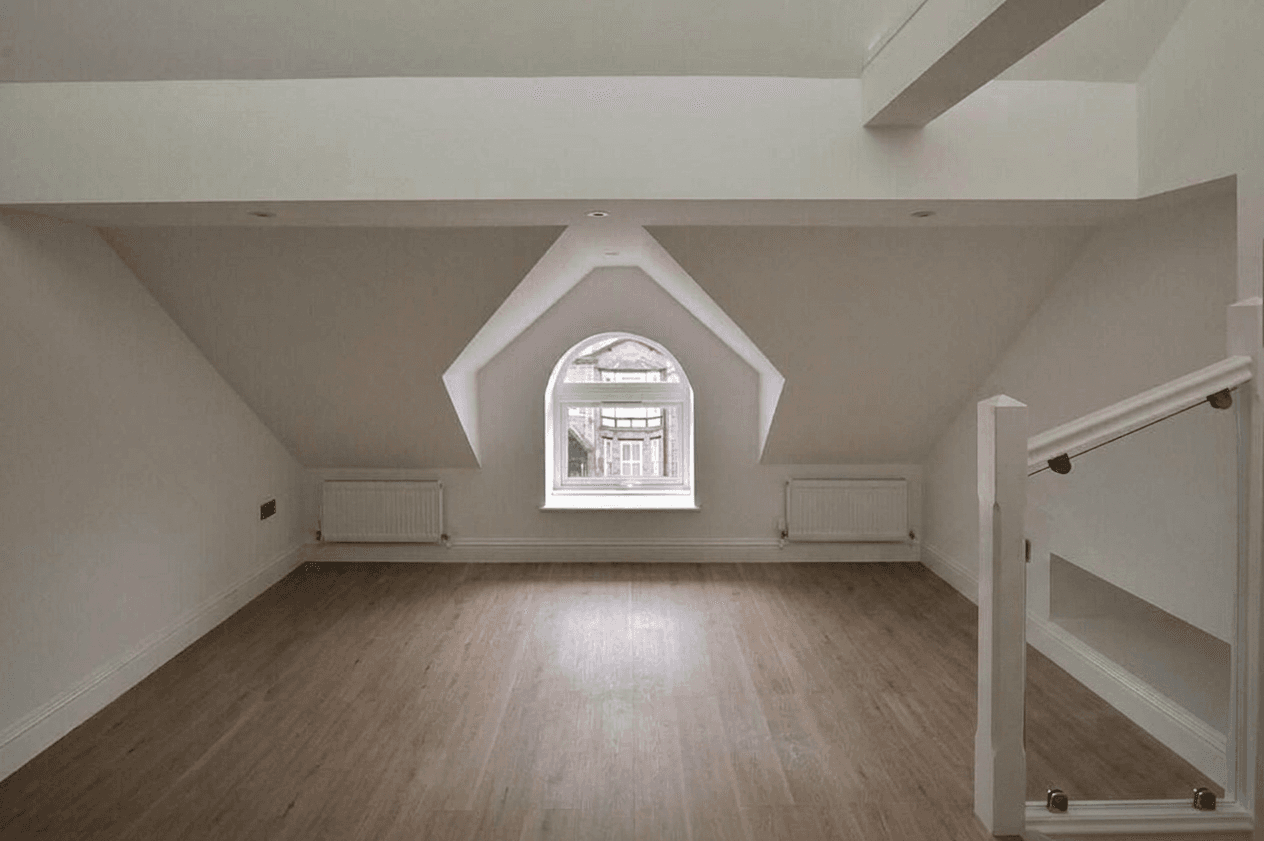 Mezzanine living space beneath the arched dormer window