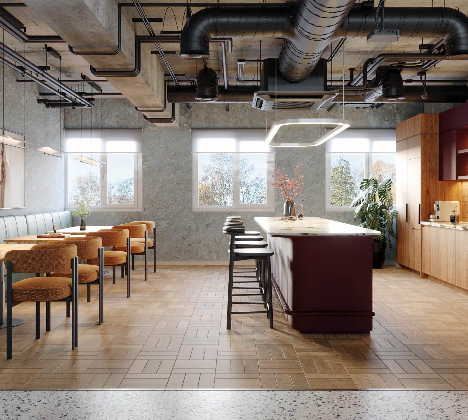 Communal kitchen and breakout with a deep red island and banquette seating