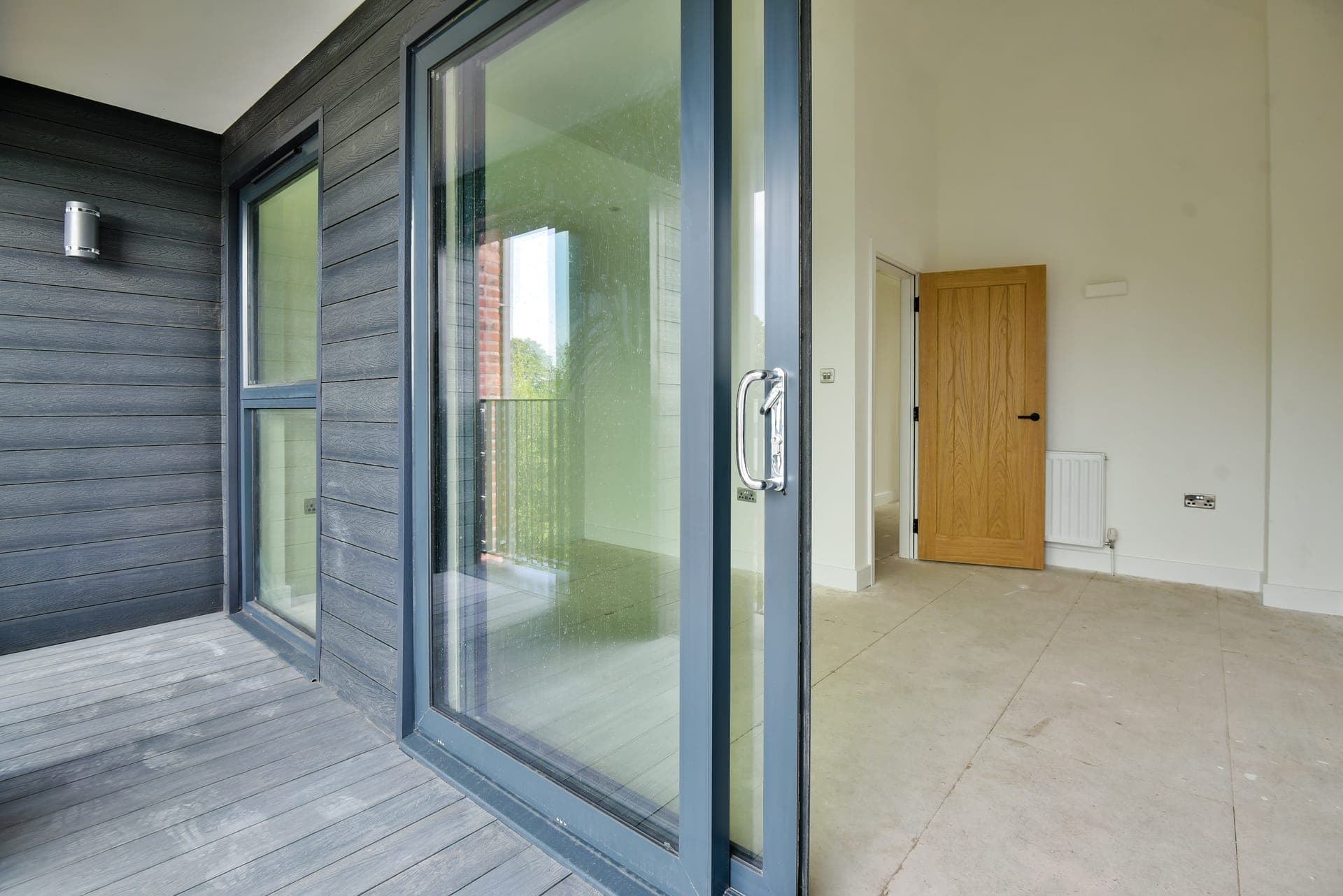 Decked terrace behind the glazed doors
