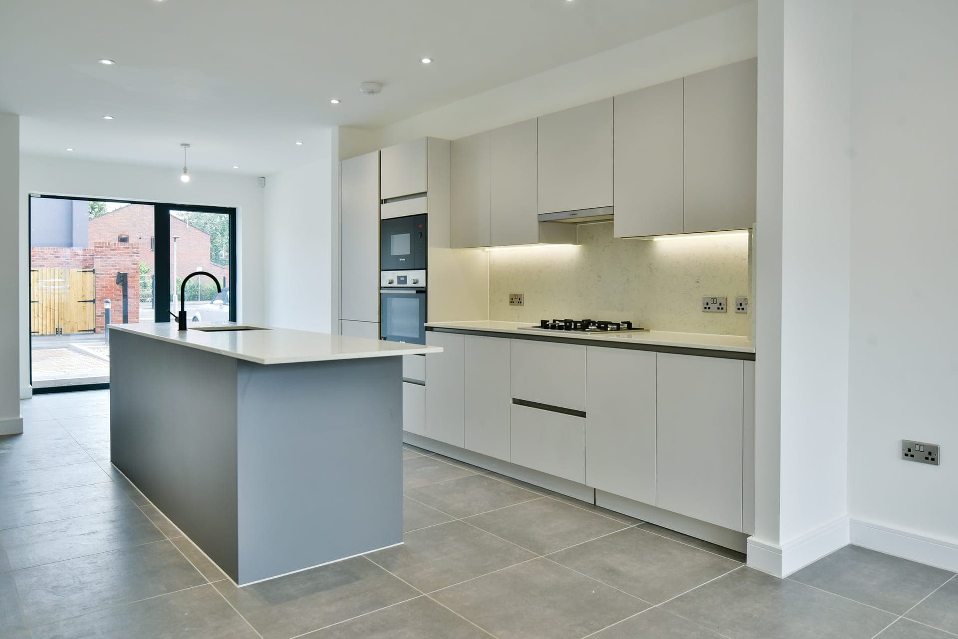 Open-plan kitchen with island, opening to the garden