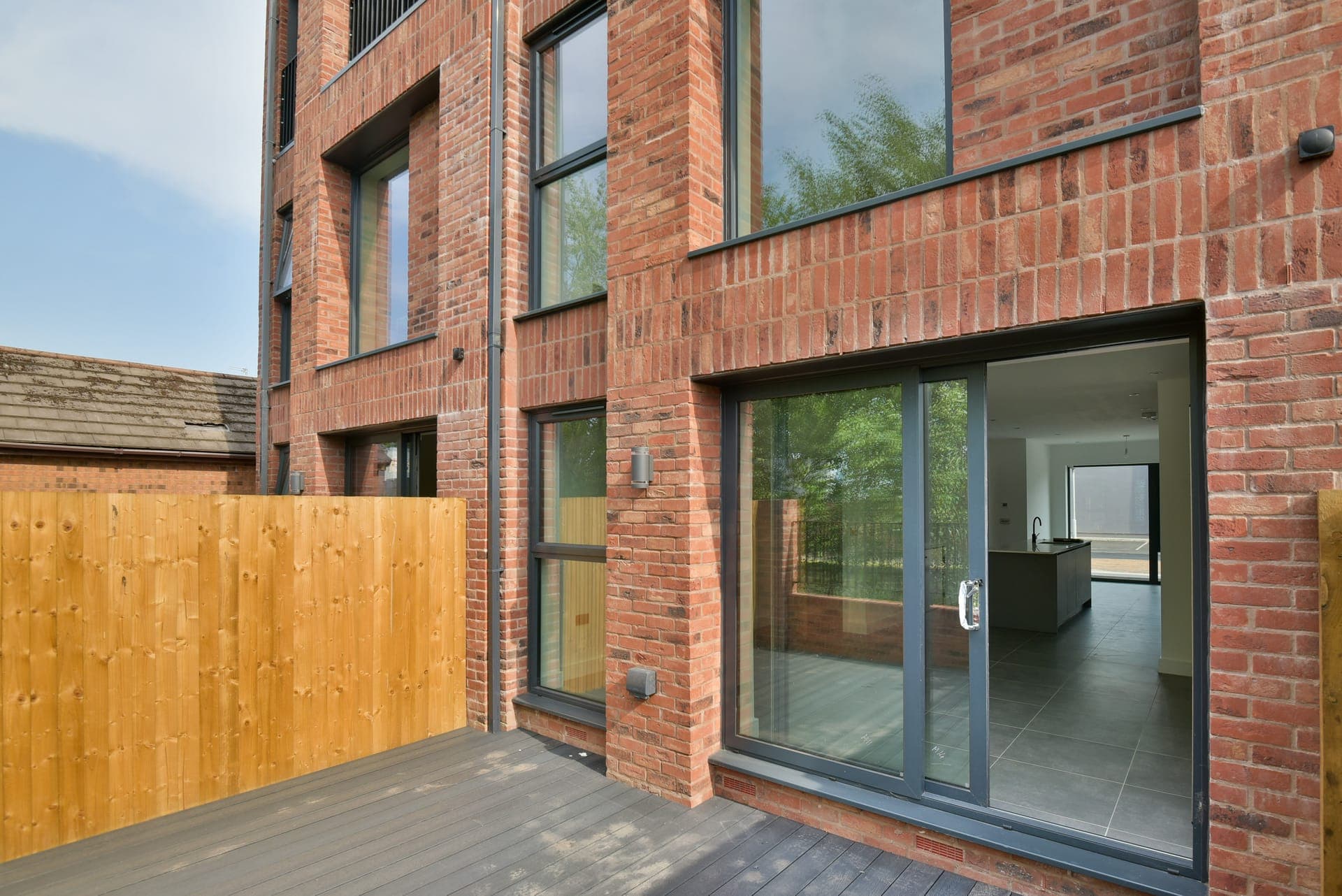 Red brick and full-height glazing at the rear