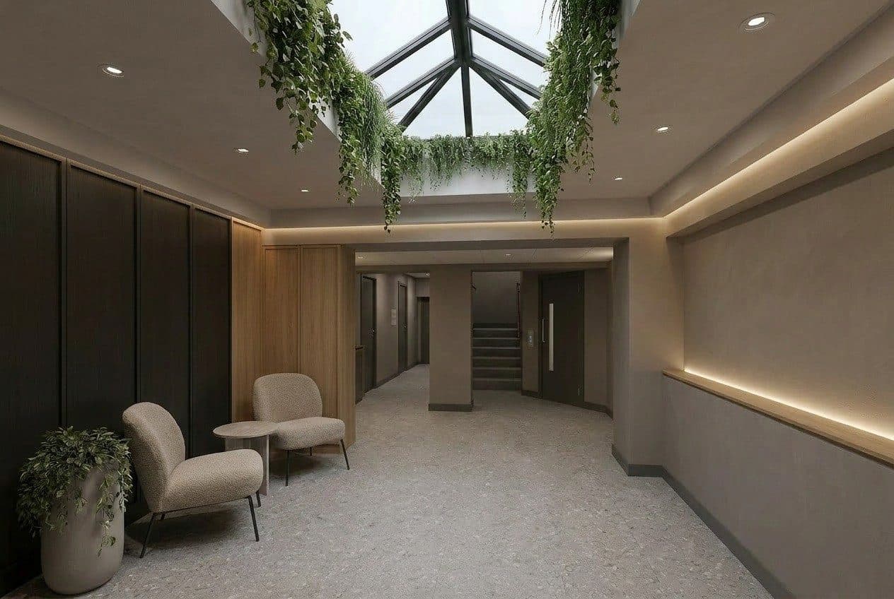 Reception and atrium at QUBE, Stockport, with planting beneath the rooflight