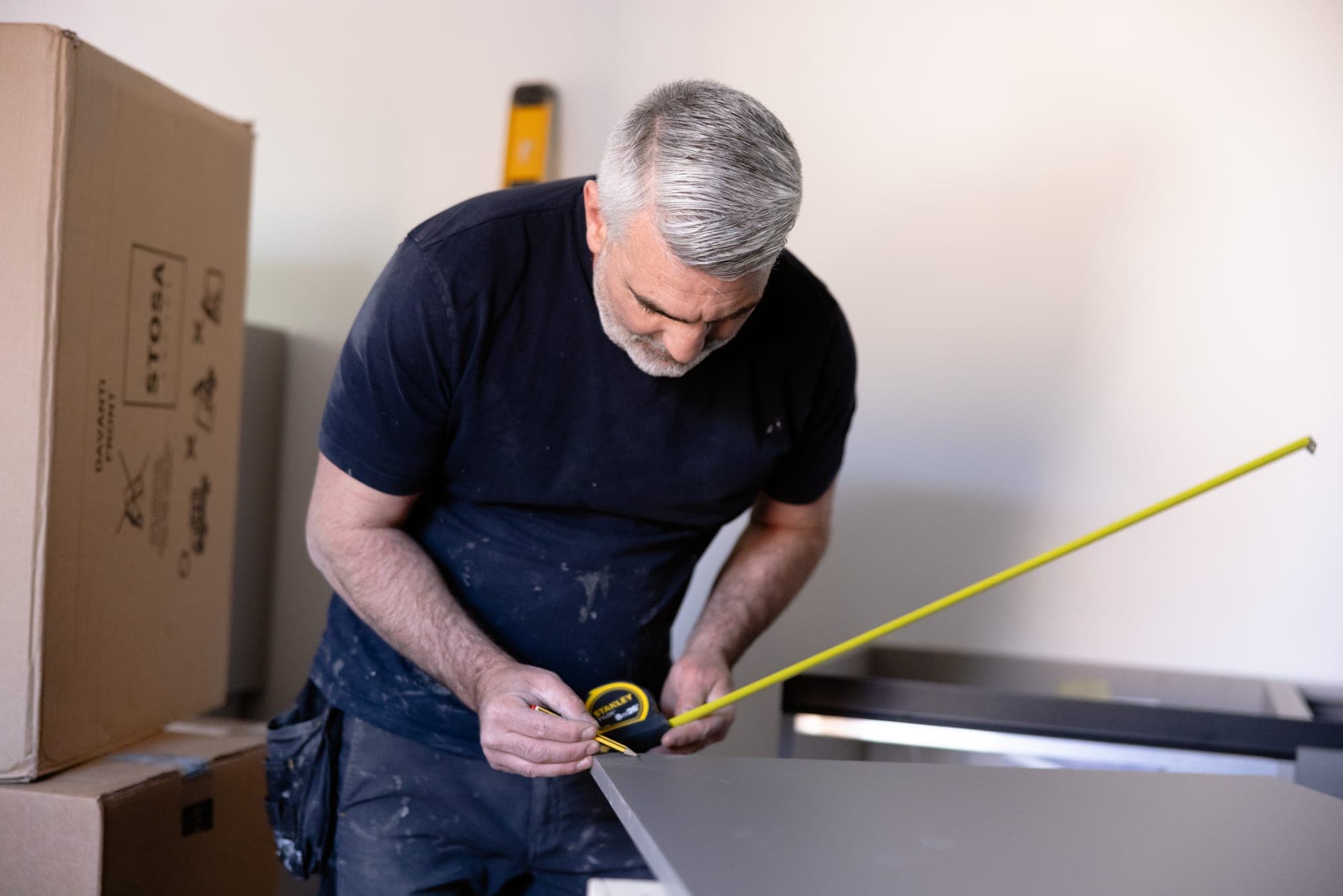 Measuring and marking a panel during a SATIS Group fit-out